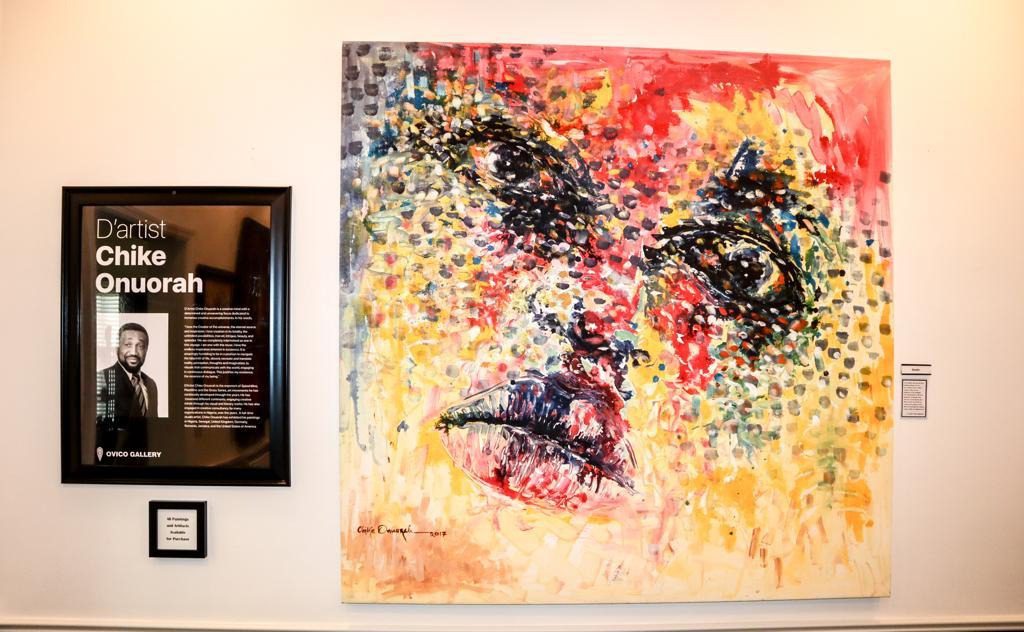 Artist Chike Onuorah with his artwork highlighting African heritage.
